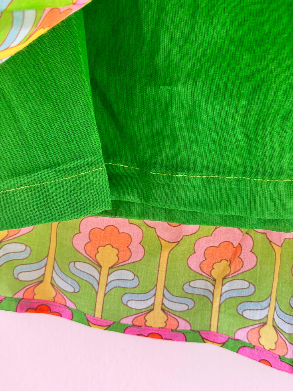 Close-up of kids' vibrant green cotton lehenga skirt showing soft cotton lining used