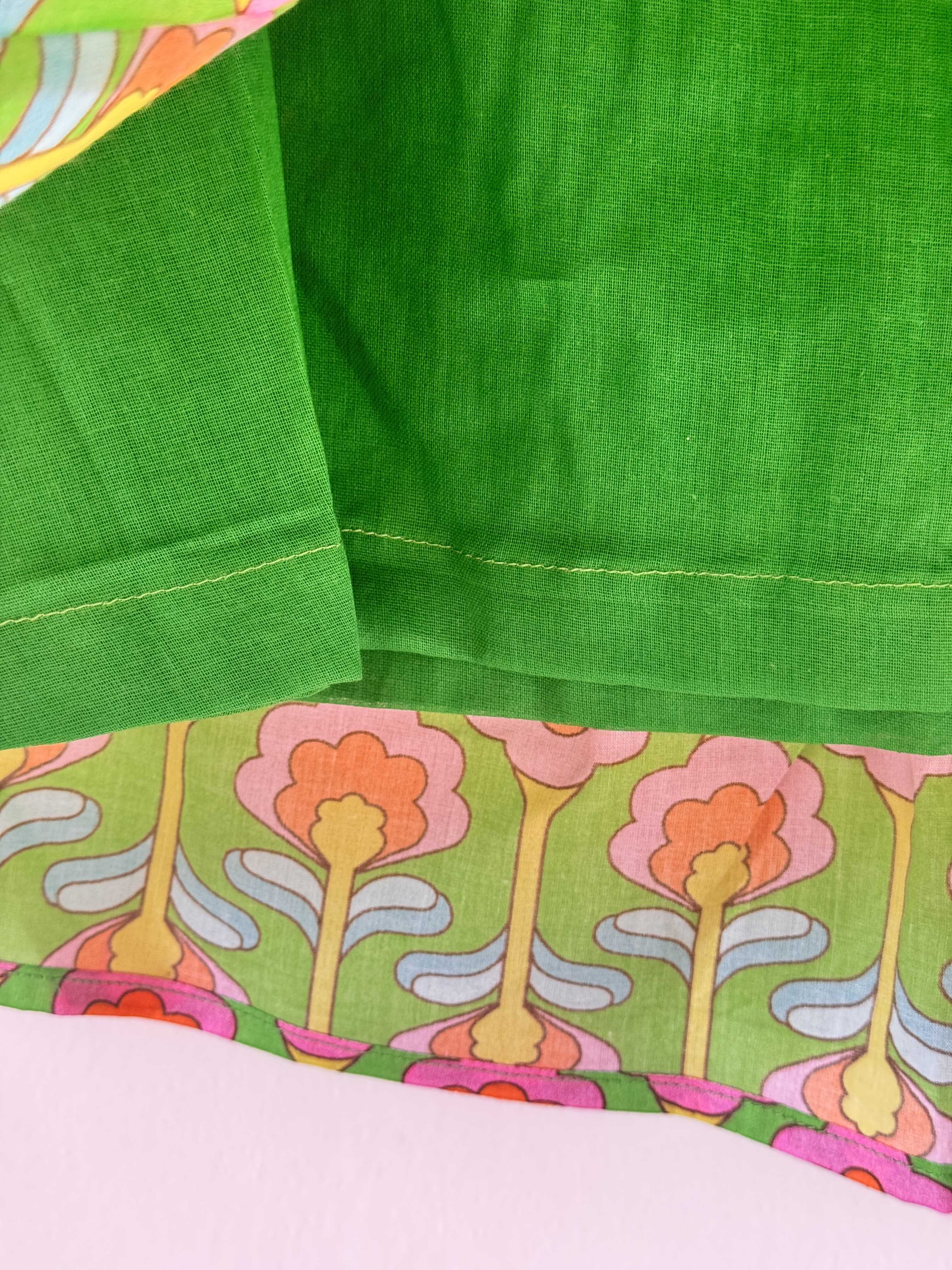 Close-up of kids' vibrant green cotton lehenga skirt showing soft cotton lining used