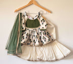 Girls' off-white and green floral cotton kurti and sharara set with a matching green net dupatta.