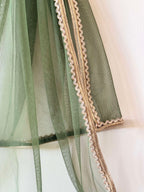 a sheer green net dupatta with a gold lace border